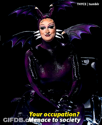 Woman In Purple And Black Costume Saying Your Occupation GIF