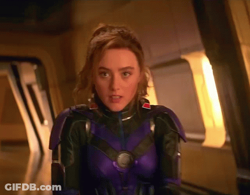 Woman In Purple And Black Suit Standing In Front Of Window GIF