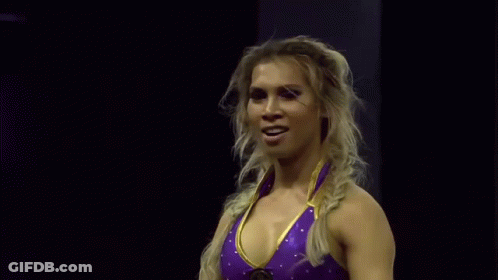 Woman In Purple And Gold Wrestling Outfit Waving GIF