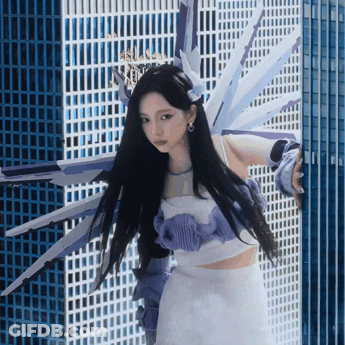Woman In Purple And White Outfit By Building GIF