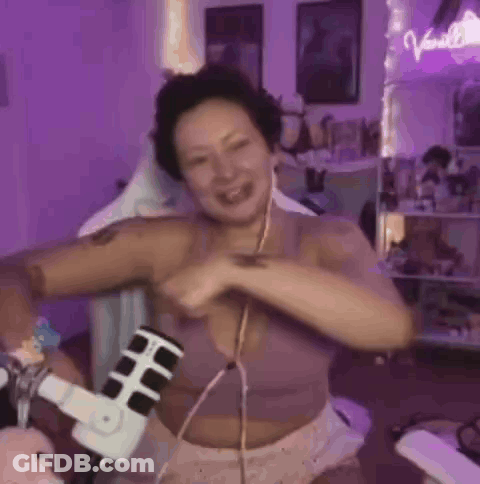 Woman In Purple Bra Dancing At Microphone GIF