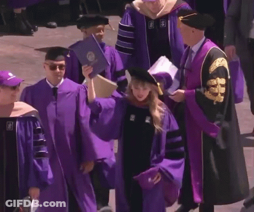 Woman In Purple Cap And Gown Holding Diploma With Letter S GIF
