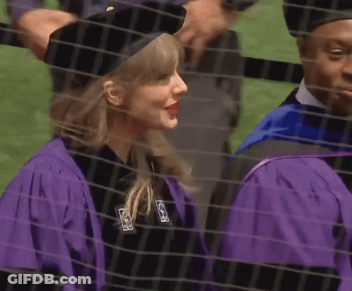 Woman In Purple Cap And Gown Next To Man In Black Hat GIF
