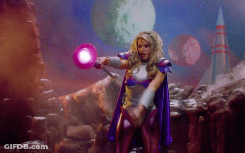 Woman In Purple Cape Holding Purple Object GIF