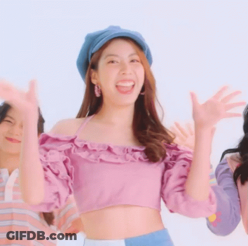 Woman In Purple Crop Top And Blue Hat Smiling GIF