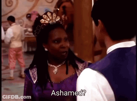 Woman In Purple Dress And Tiara Talking To Man In White Vest GIF