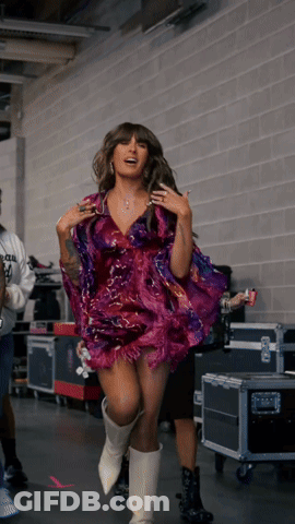 Woman In Purple Dress And White Boots In Hallway GIF