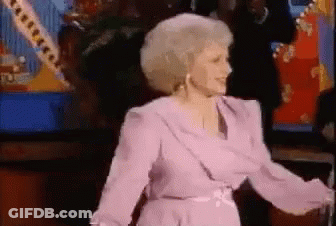 Woman In Purple Dress Dancing In Front Of Crowd GIF