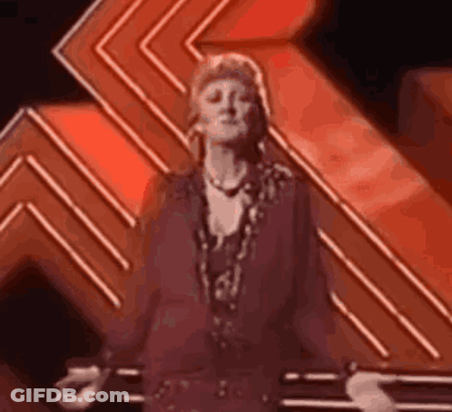 Woman In Purple Dress Dancing On Stage GIF