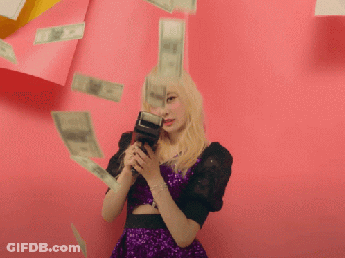 Woman In Purple Dress Holding Camera Surrounded By Money GIF