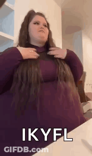 Woman In Purple Dress Holding Hair GIF