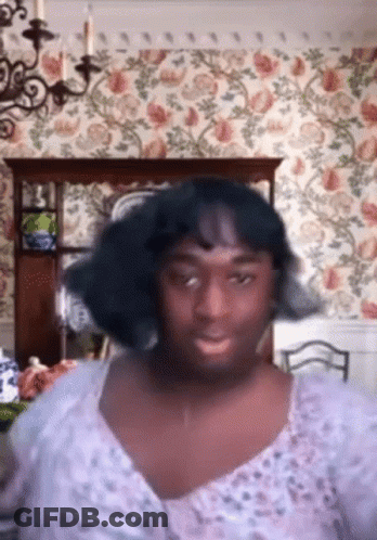 Woman In Purple Dress In Floral Dining Room GIF