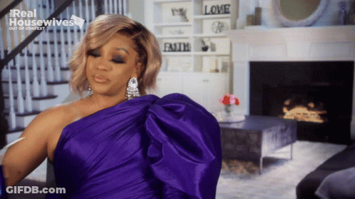 Woman In Purple Dress In Front Of Fireplace Real Housewives GIF