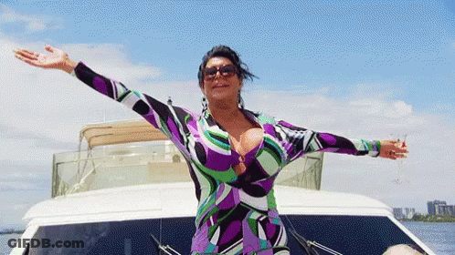 Woman In Purple Dress On Boat With Arms Outstretched GIF