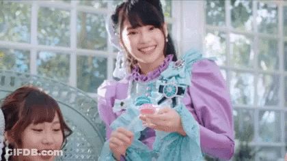 Woman In Purple Dress Smiling Holding Glass GIF