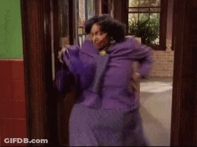 Woman In Purple Dress Standing By Door GIF