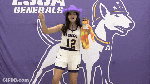 Woman In Purple Hat And LSU Jersey In Front Of Purple Banner GIF