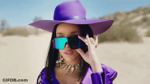 Woman In Purple Hat And Sunglasses Covering Eyes GIF