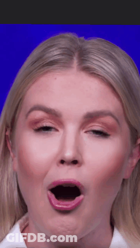 Woman In Purple Jacket And Necklace At Microphone GIF