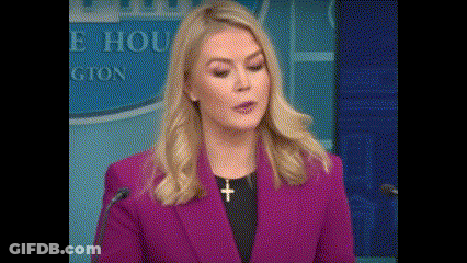 Woman In Purple Jacket And Necklace At Microphone GIF