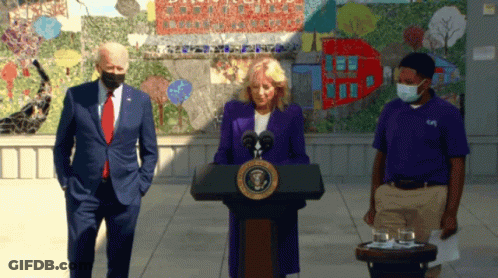 Woman In Purple Jacket At Podium With United States Of America Seal GIF