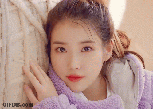 Woman In Purple Jacket Hand On Face GIF