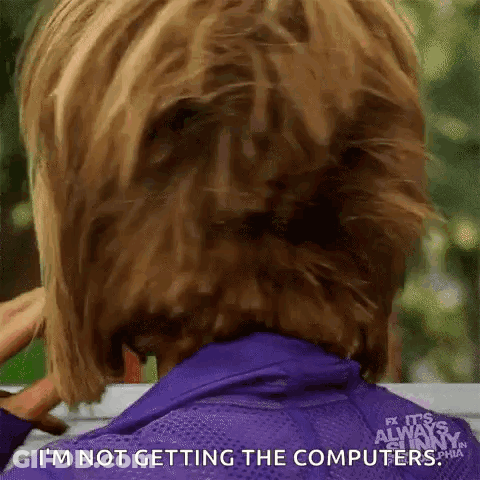 Woman In Purple Jacket Holding Hair In Bun GIF