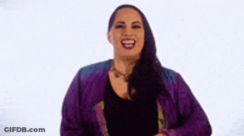 Woman In Purple Jacket Laughing And Holding Hair GIF