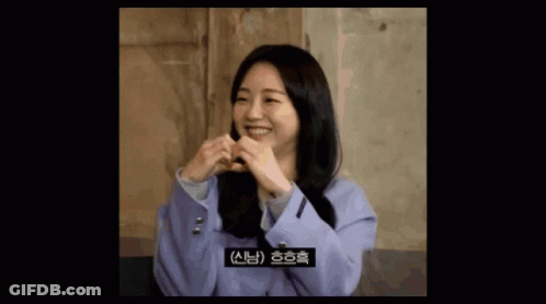 Woman In Purple Jacket Making Heart With Hands GIF