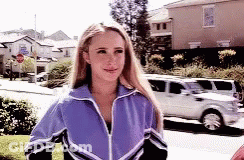 Woman In Purple Jacket Walking Down Street GIF