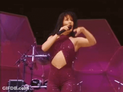 Woman In Purple Jumpsuit Singing Into Microphone GIF