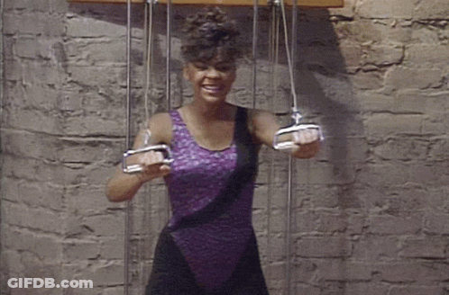 Woman In Purple Leotard Holding Pulleys GIF