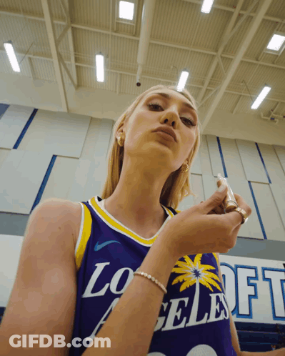 Woman In Purple Los Angeles Jersey Looking Down GIF