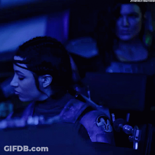 Woman In Purple Outfit Sitting In Dark Room GIF
