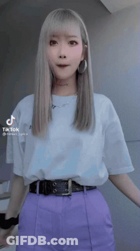 Woman In Purple Pants And White T-Shirt With TikTok Sticker GIF