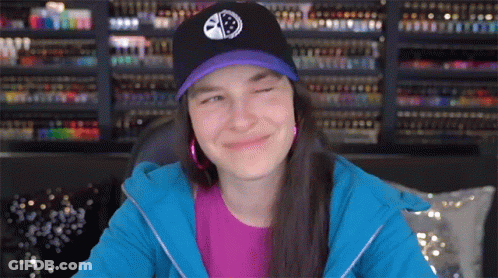 Woman In Purple Shirt And Black Hat With Smiley Face GIF