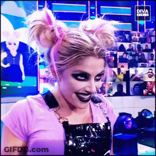 Woman In Purple Shirt And Black Overalls Smiling In Front Of Diva Screen GIF