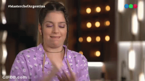 Woman In Purple Shirt Applauding In Front Of Masterchef Argentina Screen GIF