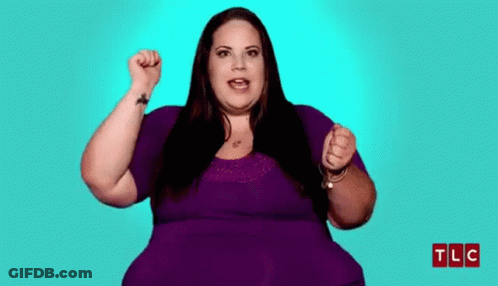 Woman In Purple Shirt Holding Fist Up GIF