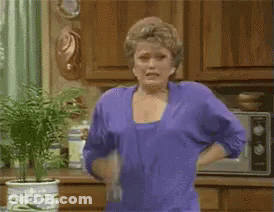 Woman In Purple Shirt Holding Water Bottle GIF