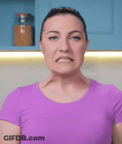 Woman In Purple Shirt Making Face GIF