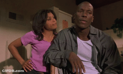 Woman In Purple Shirt Next To Man In White GIF