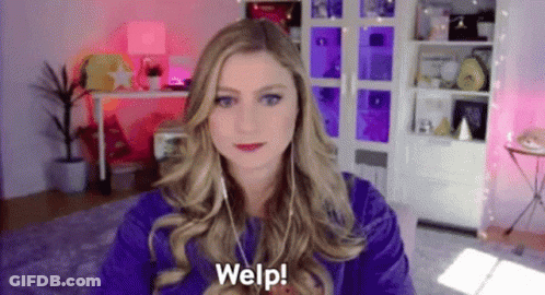 Woman In Purple Shirt On Video Call With Headphones GIF