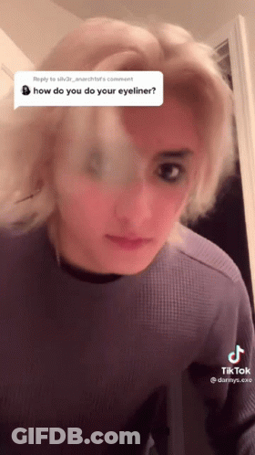 Woman In Purple Shirt Questioning Eyeliner GIF