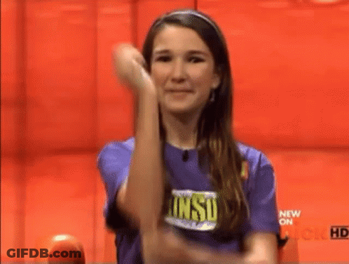 Woman In Purple Shirt Raising Arm GIF