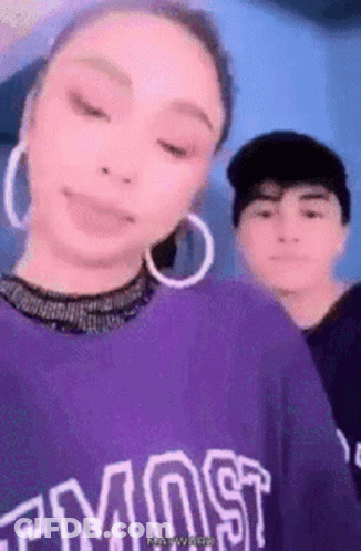 Woman In Purple Shirt Saying Most Beside Man GIF