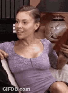 Woman In Purple Shirt Sitting With Man On Couch GIF