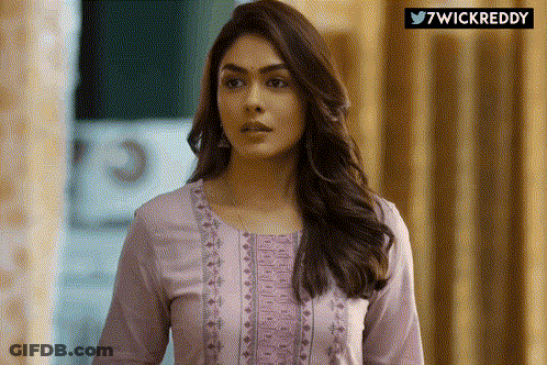 Woman In Purple Shirt Standing In Front Of 7Wickreddy Sign GIF