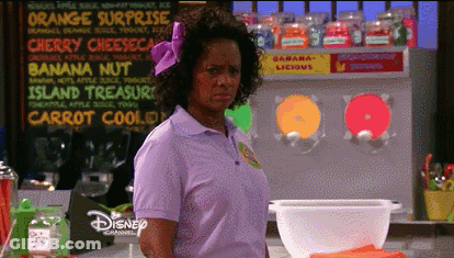 Woman In Purple Shirt Standing In Front Of Banana Nut Sign GIF