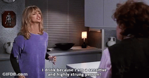Woman In Purple Shirt Talking To Another Woman Holding Wine GIF